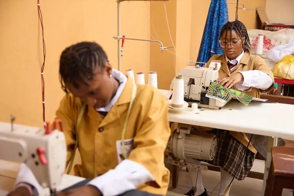 A student at an industrial sewing machine