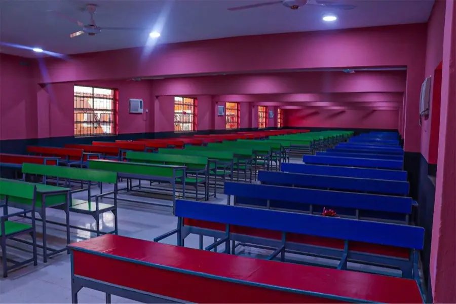 A tiered hall lined with coloured benches