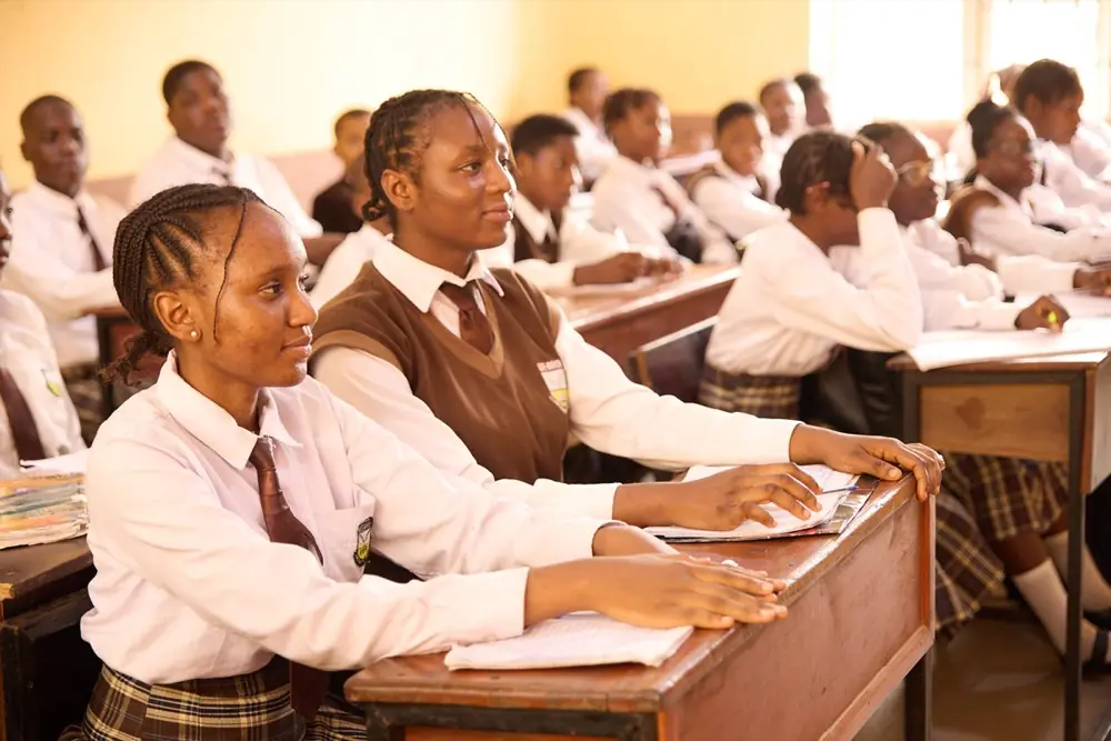 Students raising their hands to answer in class
