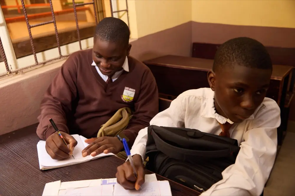 A teacher helping a student at their desk